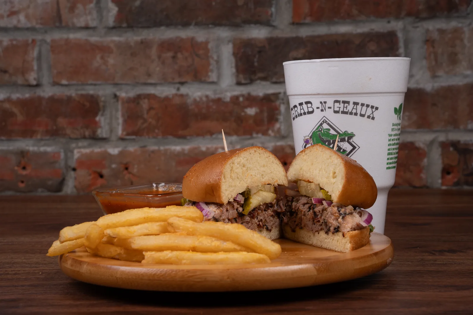 Chopped brisket sandwich with fries and a fountain drink